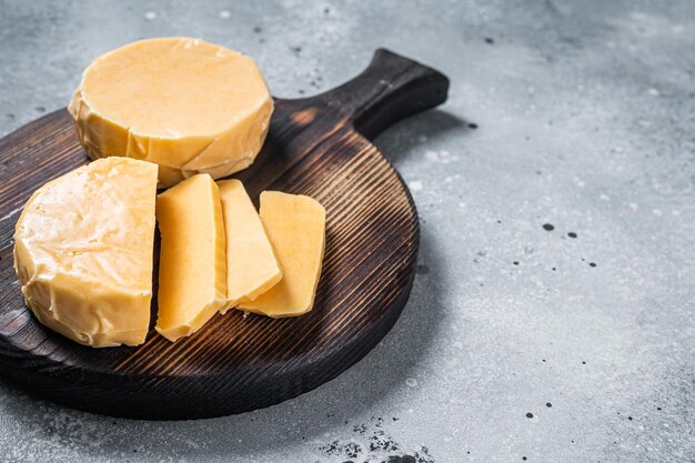 Halloumi sliced cheese on kitchen table. Gray background. Top view. Copy space.