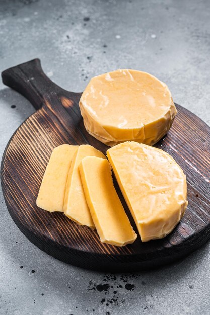 Halloumi sliced cheese on kitchen table. Gray background. Top view.