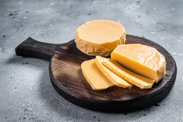 Halloumi sliced cheese on kitchen table. Gray background. Top view.