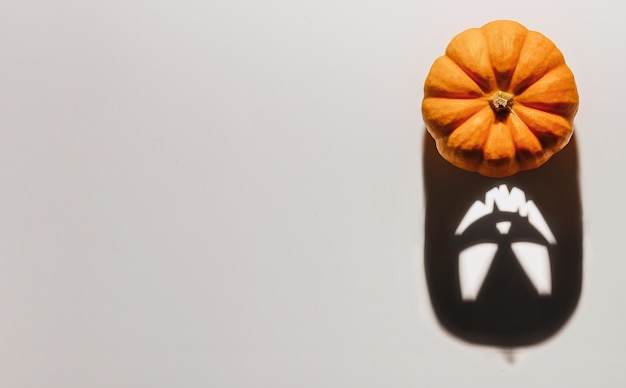 Halloween-achtergrondconcept. Jack O pompoen boos gezicht schaduw. Spooky lachende schaduw van een oranje pompoenlantaarn bovenaanzicht close-up, Halloween-feestontwerp