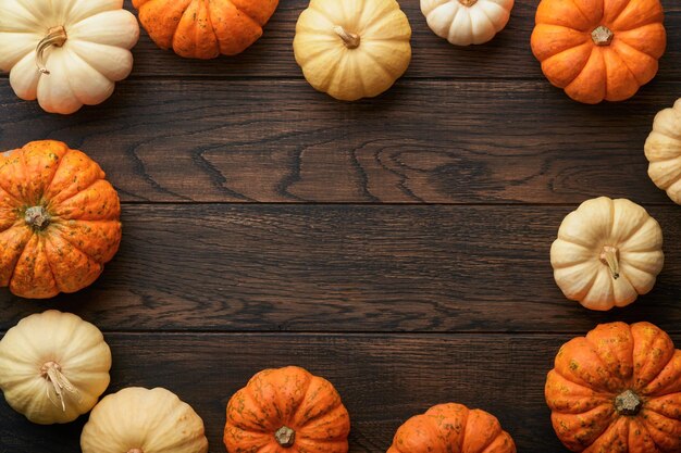 Halloween background Flock of black bats spider pumpkin and leaves for Halloween Black paper bat silhouettes on old wooden dark background Autumn decoration Halloween concept Top view