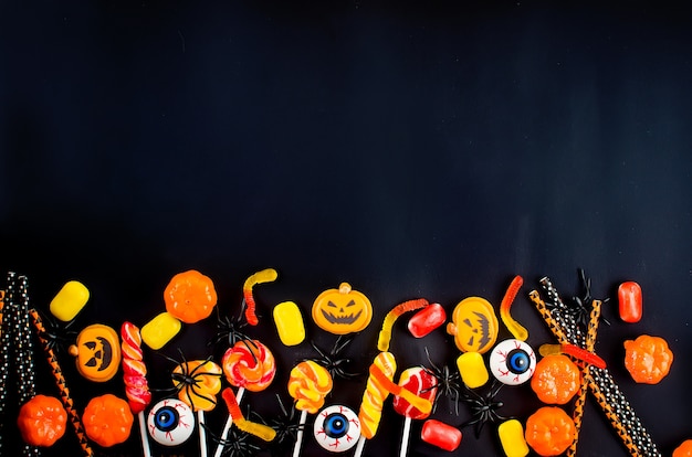 Photo halloween background with many pumpkin, candy eyes and spiders