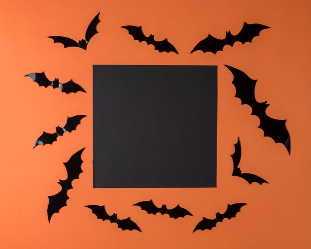 Halloween bat decorations on an orange background