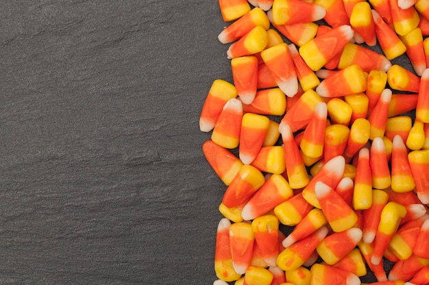 Halloween candy corn sweets on a slate background