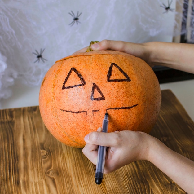 Halloween. close up of teenage girl with pumpkin at home