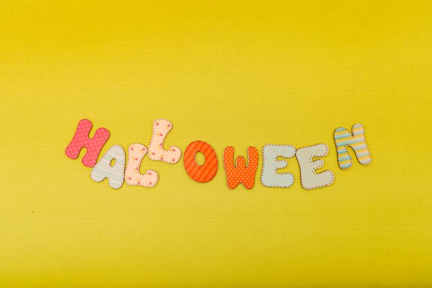 Halloween composition on light green background