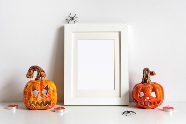 halloween composition with ceramic pumpkins jack lantern and frame on table wall background greeting card template