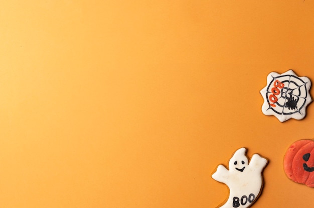 halloween concept ghost cookie on yellow background