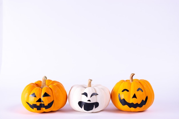 Halloween concept. orange and white pumpkins over white background.