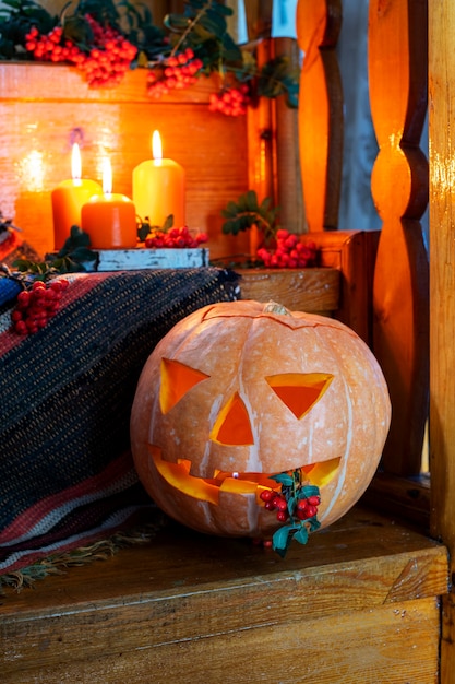 Halloween concept Rustic Halloween cardJacks lantern from pumpkin and candles