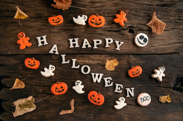 Halloween cookies on a brown wooden table. Halloween concept with homemade cookies. Celebrating happy halloween