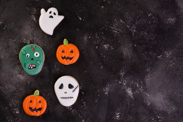 Halloween cookies on dark background - top view