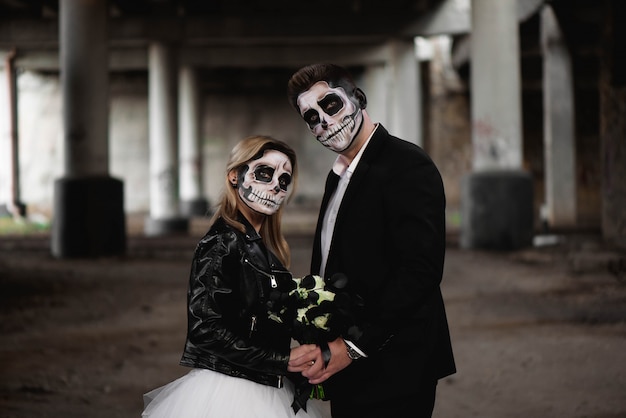 Halloween couple. Dressed in wedding clothes romantic zombie