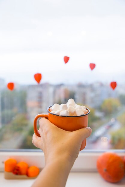 Halloween cozy mood composition on the windowsill decorative pumpkins warm plaid hygge halloween