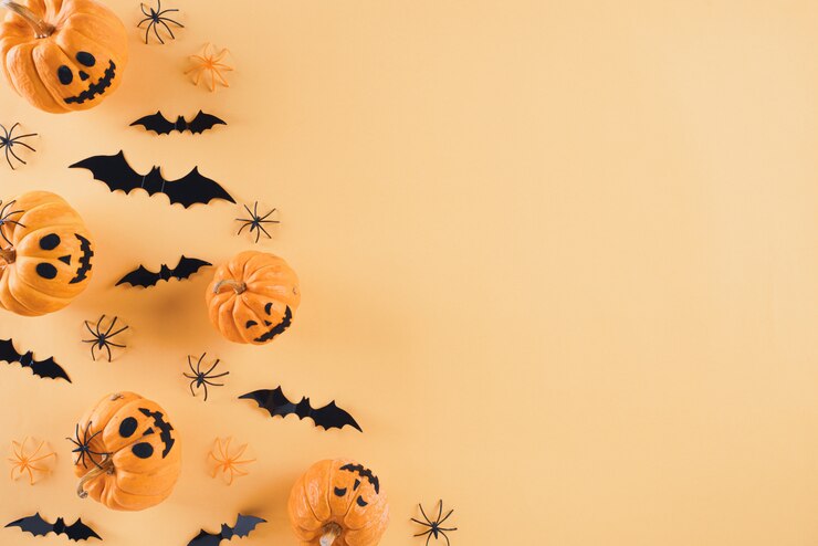 Photo オレンジ色の背景にハロウィーンの工芸品