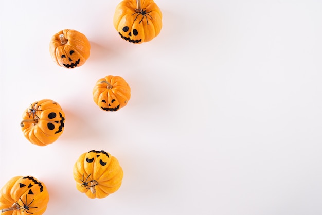 Halloween crafts, orange ghost pumpkin on white background with copy space