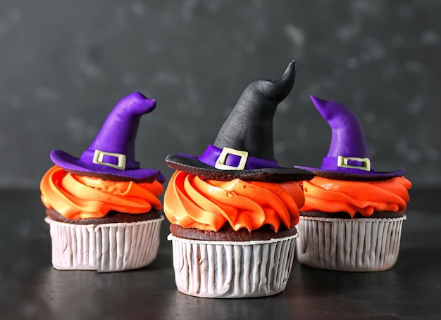 Halloween cupcakes decorated witch hat on dark background