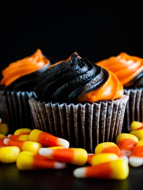 Halloween cupcakes decorated with black and orange swirled icing.