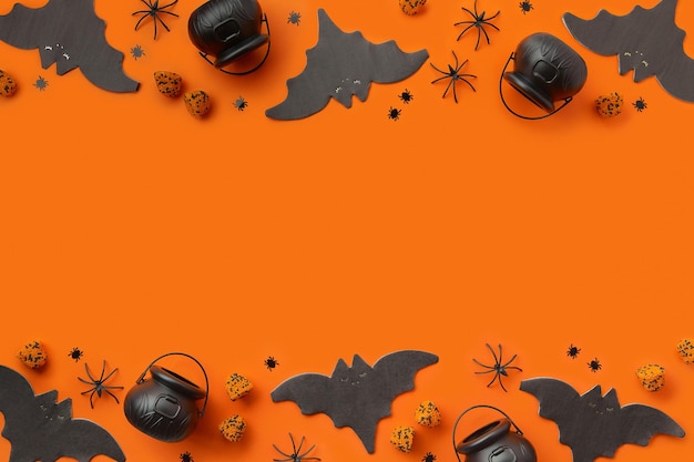 Halloween decor on an orange black background flat lay top view