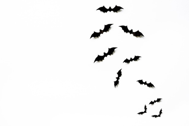 Halloween and decoration concept black 3d paper bats flying over white background