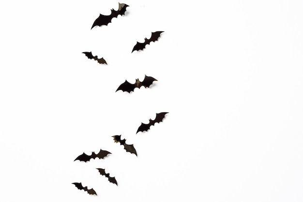 halloween and decoration concept black 3d paper bats flying over white background