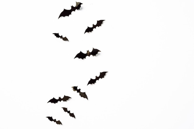 Halloween and decoration concept black 3d paper bats flying over white background