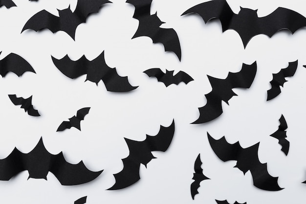 Halloween and decoration concept - paper bats flying