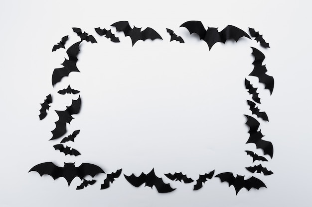 Halloween and decoration concept - paper bats flying