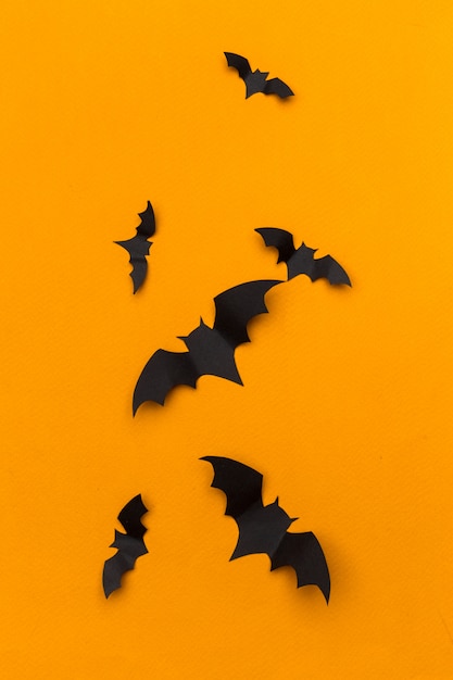 Halloween and decoration concept - paper bats flying