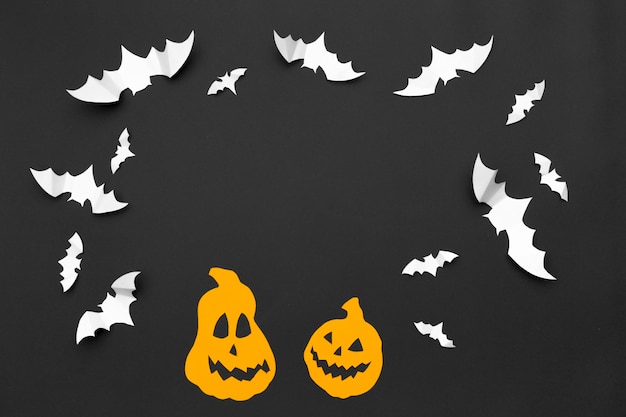 Halloween and decoration concept - paper bats flying