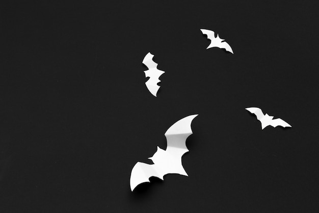 Halloween and decoration concept - paper bats flying