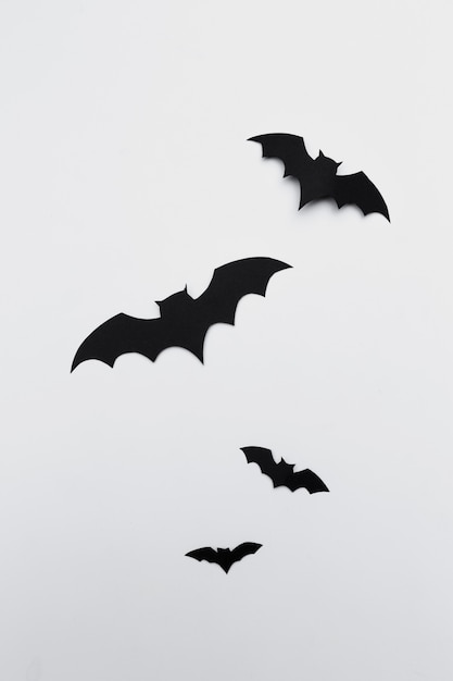 Halloween and decoration concept - paper bats flying