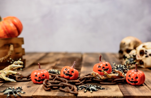 Halloween decoration. Trick or treat in autumn and fall season. Pumpkin face and scary symbol on wood background.