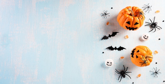 Halloween decorations made from pumpkin, paper bats and black spider