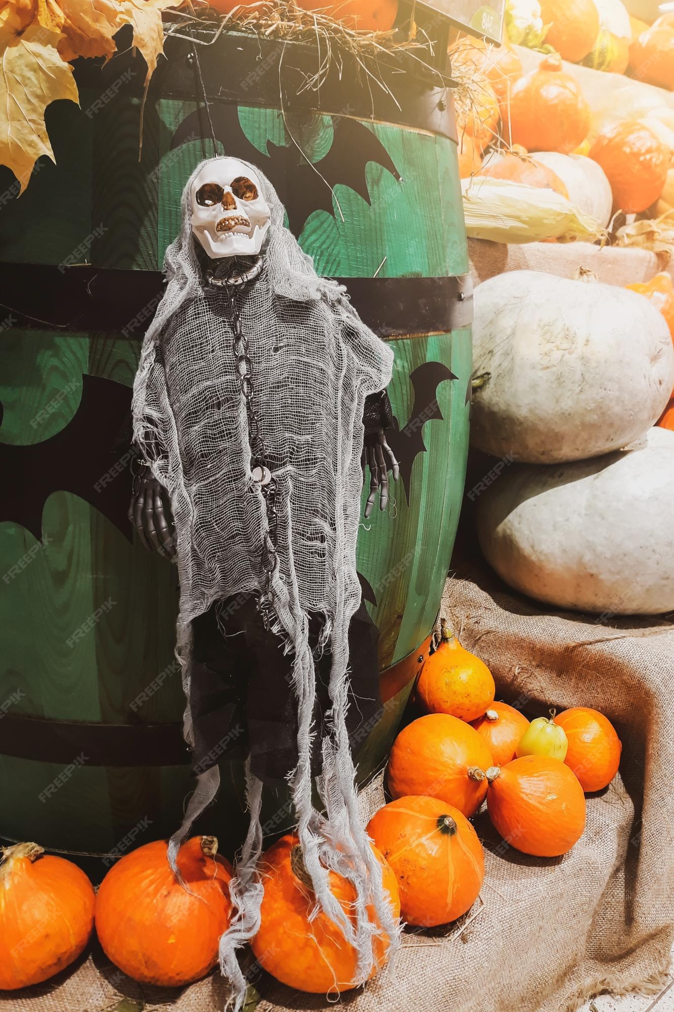 Premium Photo | Halloween decorations skeleton and fresh pumpkins ...