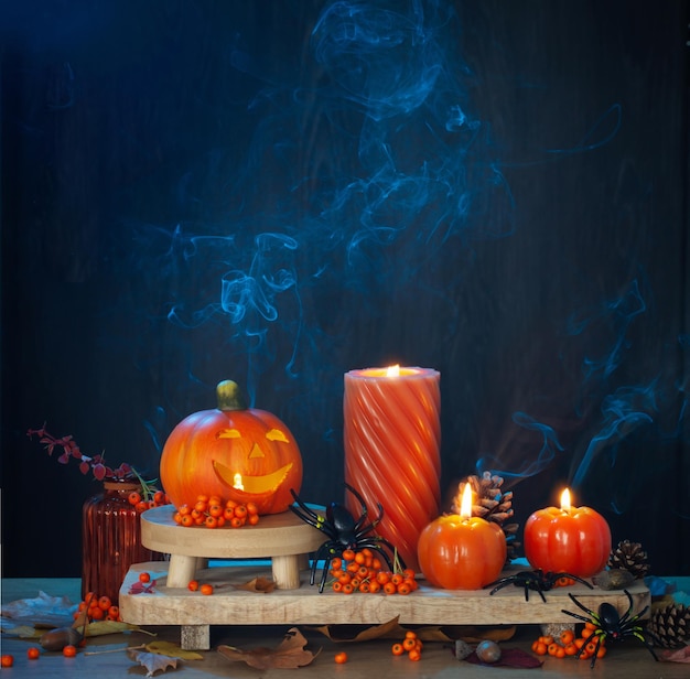 halloween decorations with pumpkin on dark wooden background