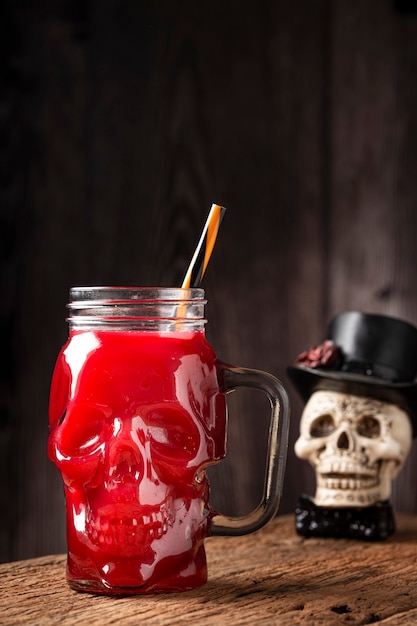 Halloween drink. Blood drink in skull glass.