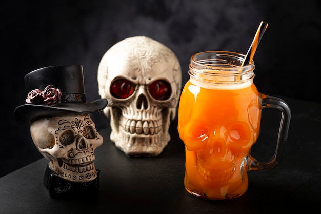 Halloween drink. Pumpkin drink in skull glass.