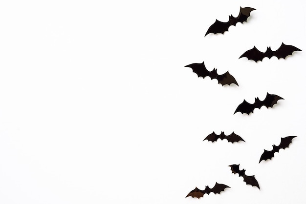 Foto halloween en decoratie concept zwarte 3d papier vleermuizen vliegen over witte achtergrond