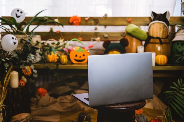 Photo halloween festivities in new normal new trick or treating regulations open laptop ready for online