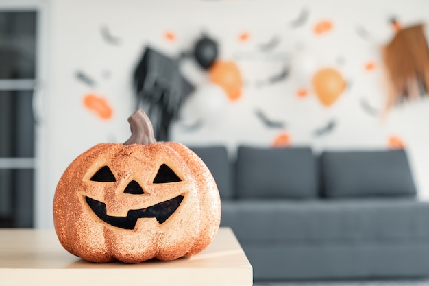 Halloween ghost pumpkin on the table.