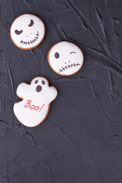 Halloween gingerbread cookies on black background.