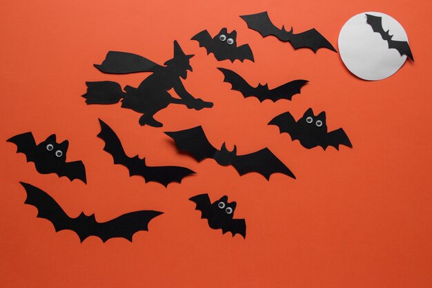 Halloween holiday. Composition with different halloween paper figures. view from above. on orange background