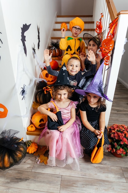 Halloween holiday party for children kids in costumes on\
staircase