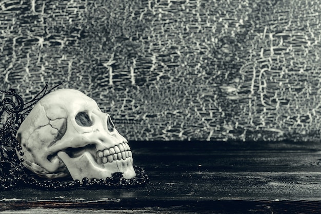 Halloween human skull on an old wooden table