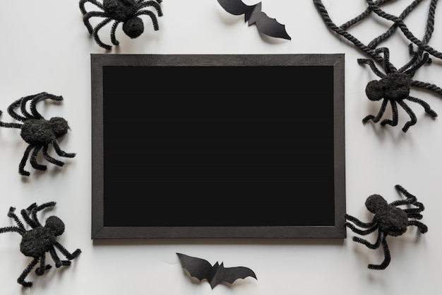 Photo halloween invitation with black spiders on grey