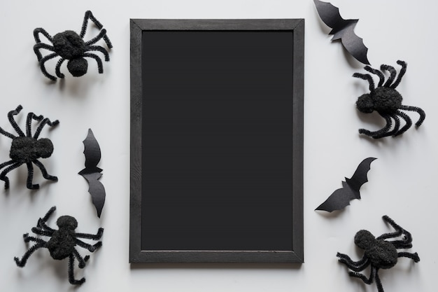 Halloween invitation with black spiders on grey