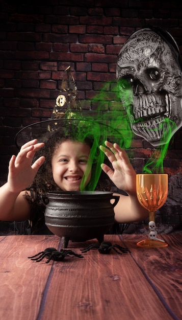 Halloween, little girl playing in a Halloween setting creating her magic potions, selective focus.