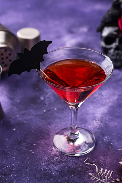 Halloween martini cocktail on purple background