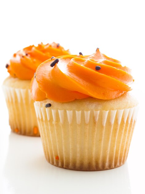 Halloween orange and black cupcakes on white background.